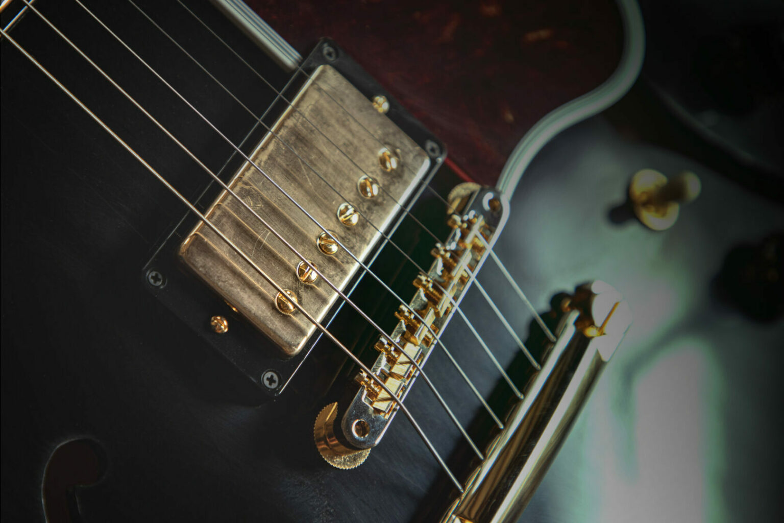 Closeup of an electric guitar with humbuckers