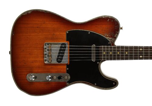 Part of a vintage sunburst electric guitar, showing the lower bout, binding, and worn finish.